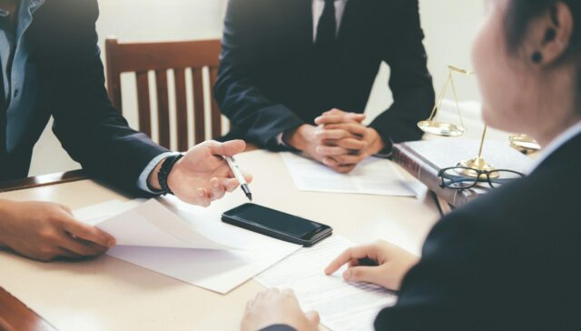 Lawyer and attorney having team meeting at law firm.