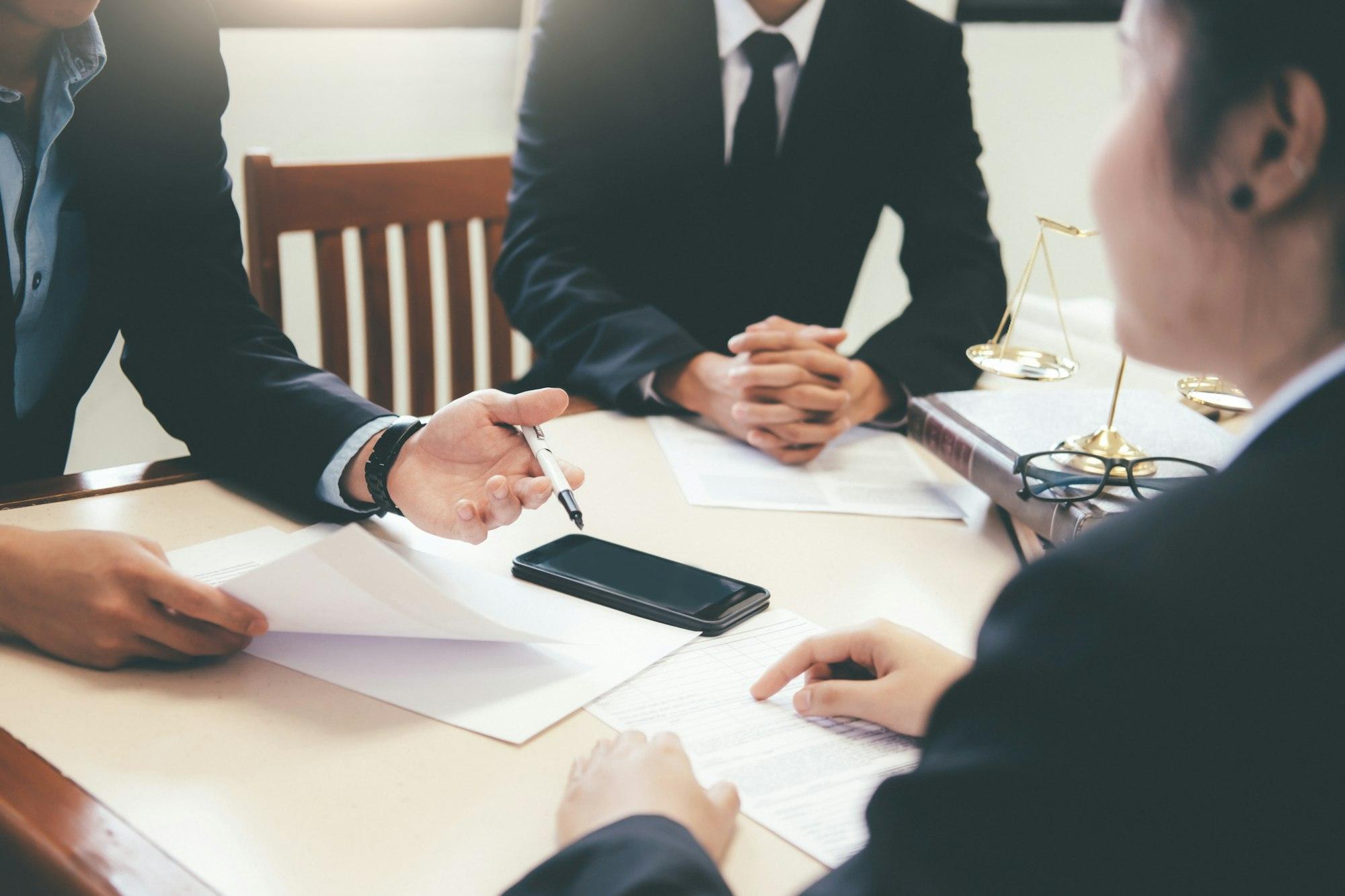 Lawyer and attorney having team meeting at law firm.